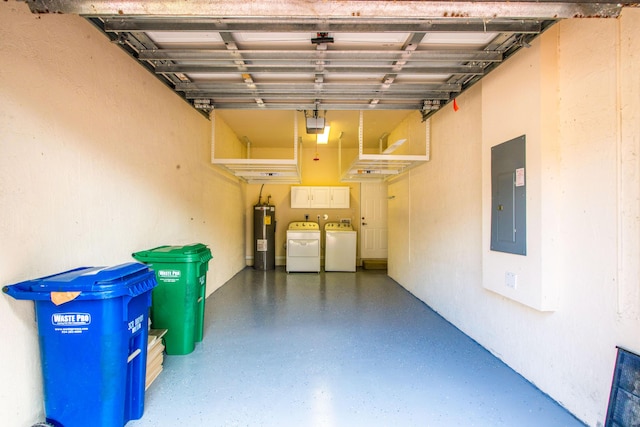 garage with electric panel, washer and dryer, and electric water heater