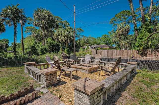 view of yard featuring an outdoor fire pit and a fenced backyard