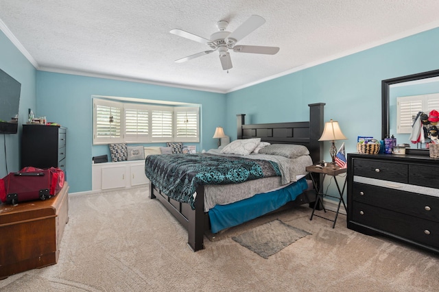 carpeted bedroom with a ceiling fan, a textured ceiling, and crown molding