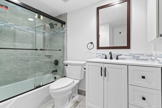 bathroom featuring backsplash, enclosed tub / shower combo, toilet, and vanity