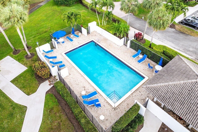 community pool featuring a fenced backyard