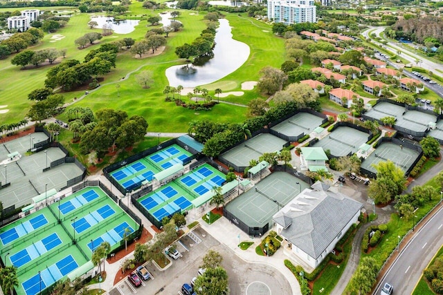 drone / aerial view featuring view of golf course and a water view