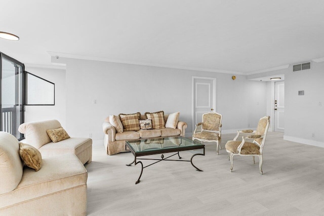 living room featuring wood finished floors, visible vents, and ornamental molding