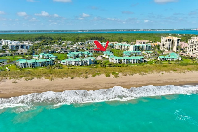 drone / aerial view with a beach view and a water view