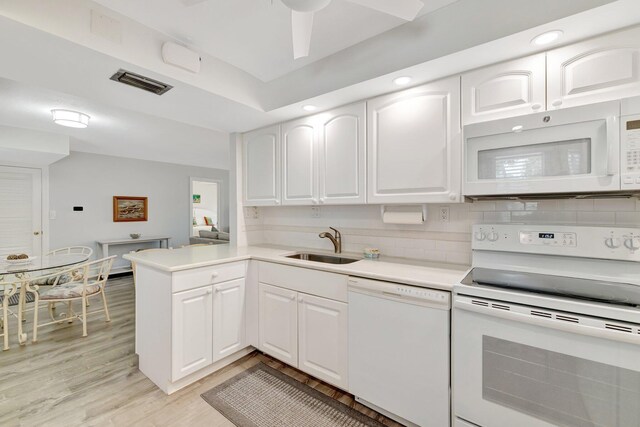 2400 S Ocean Dr Unit C623, Hutchinson Island, FL 34949 - kitchen featuring white appliances, a sink, white cabinetry, light wood-style flooring, and recessed lighting