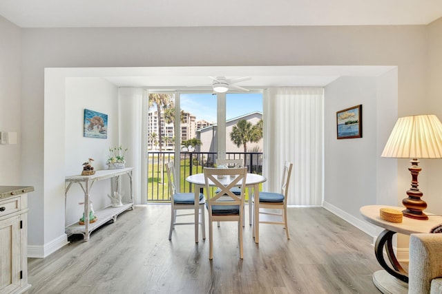 2400 S Ocean Dr Unit C623, Hutchinson Island, FL 34949 - dining area featuring baseboards, light wood-style flooring, and ceiling fan