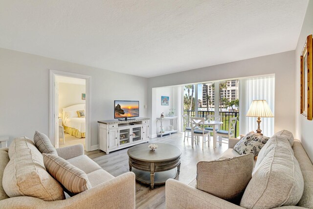 2400 S Ocean Dr Unit C623, Hutchinson Island, FL 34949 - living room featuring light wood-style floors and baseboards