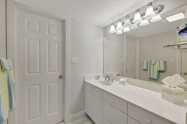 2400 S Ocean Dr Unit C623, Hutchinson Island, FL 34949 - bathroom featuring vanity, a textured ceiling, and baseboards