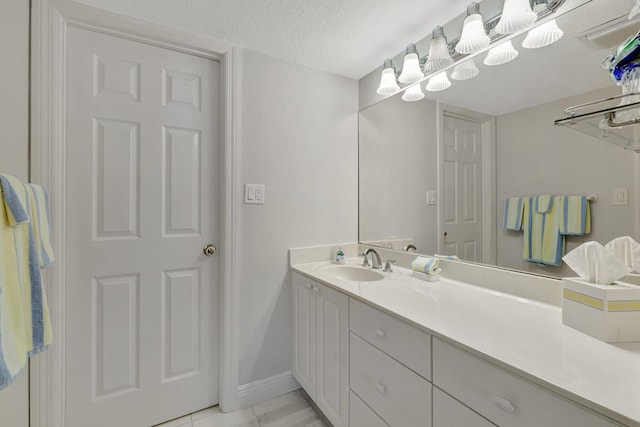 2400 S Ocean Dr Unit C623, Hutchinson Island, FL 34949 - bathroom with vanity, baseboards, a textured ceiling, and tile patterned flooring