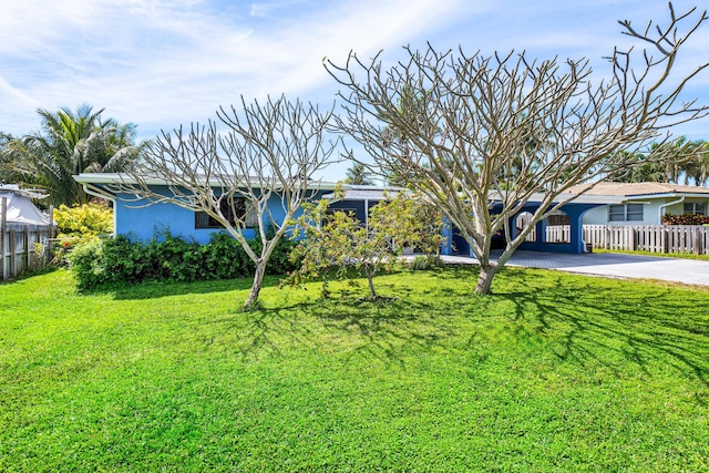 view of front of home with a front yard, fence, aphalt driveway, and stucco siding