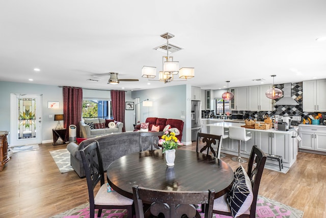 dining area with baseboards, recessed lighting, visible vents, and light wood-type flooring