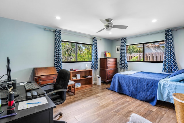 bedroom with recessed lighting, multiple windows, a ceiling fan, and wood finished floors