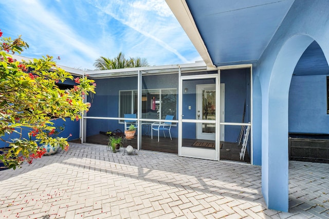 view of patio / terrace with a sunroom