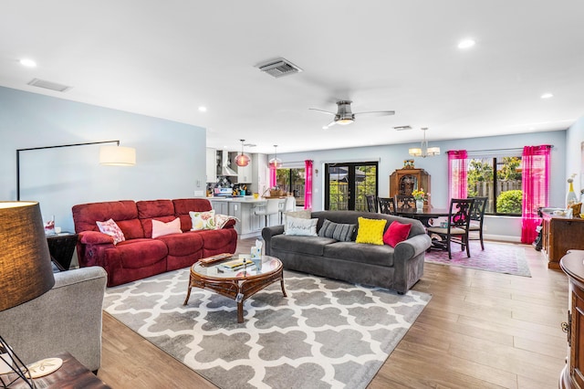 living area with recessed lighting, visible vents, and light wood finished floors