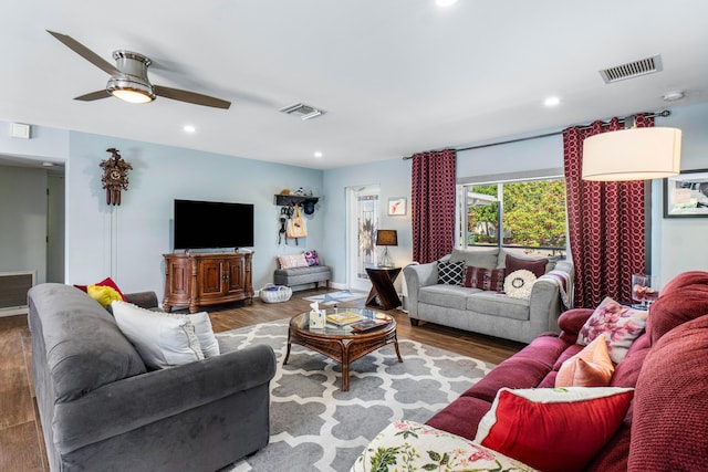 living room featuring visible vents, recessed lighting, and wood finished floors