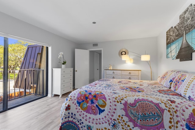 bedroom featuring visible vents, wood finished floors, and access to exterior