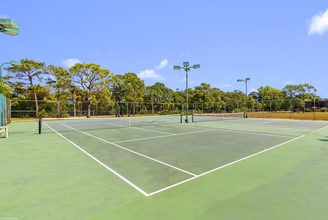 view of sport court featuring fence