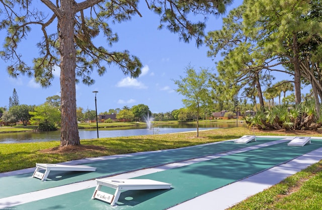 view of property's community featuring a yard and a water view