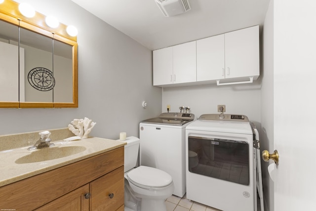 bathroom featuring vanity, visible vents, tile patterned flooring, toilet, and washing machine and dryer