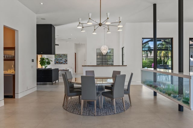 dining room featuring baseboards and an inviting chandelier