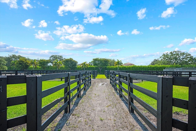 view of yard featuring a rural view and fence