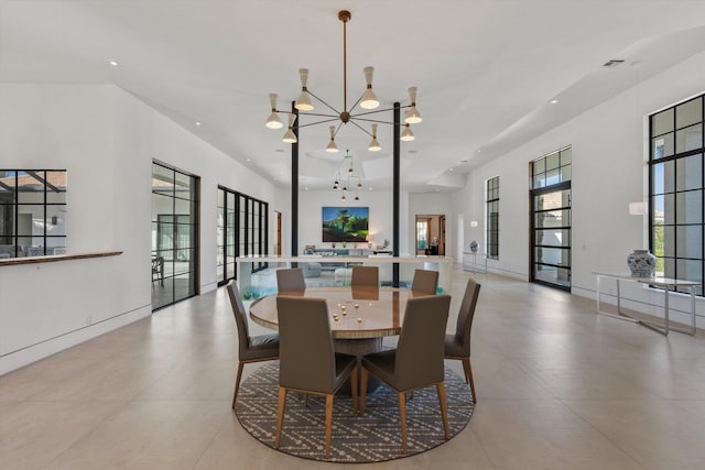 dining room with a chandelier and recessed lighting