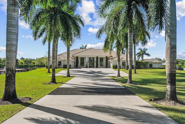 view of property's community with a yard and driveway