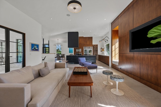 living area with recessed lighting and wood walls