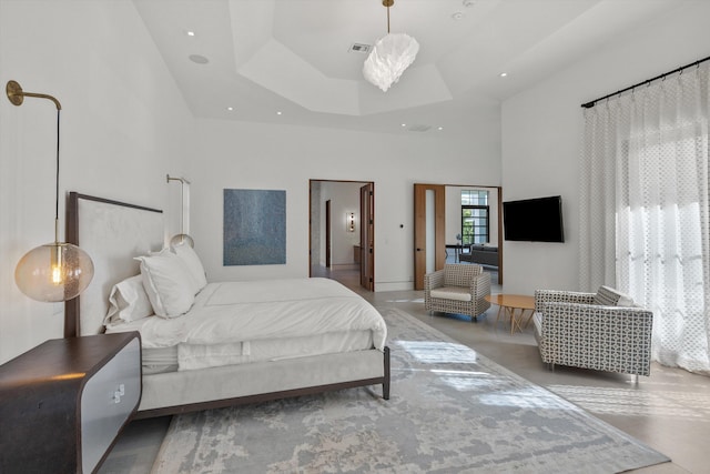 bedroom featuring recessed lighting, visible vents, a raised ceiling, and a high ceiling