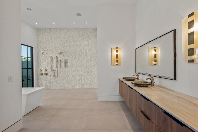 full bath with vanity, a soaking tub, a towering ceiling, walk in shower, and tile patterned floors