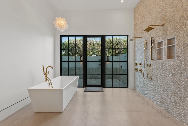 interior space with a towering ceiling and a freestanding tub