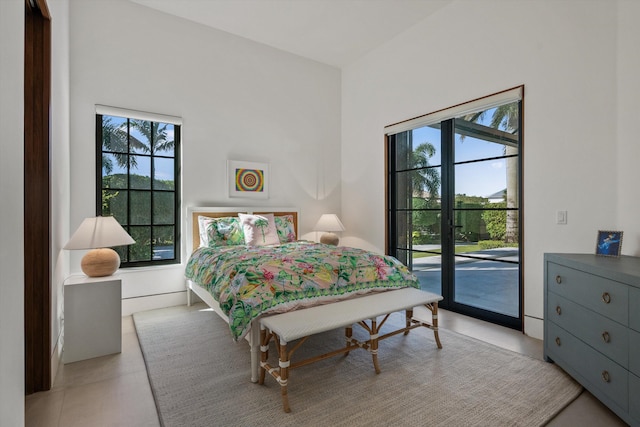 bedroom with light tile patterned floors and access to outside