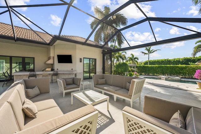 view of patio / terrace featuring outdoor lounge area, a lanai, a pool with connected hot tub, and outdoor dry bar