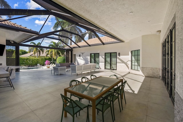 view of patio / terrace featuring an outdoor living space, outdoor dining area, and glass enclosure