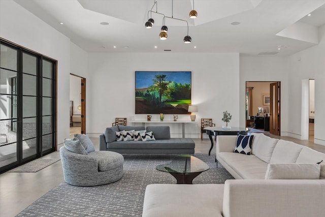 living room featuring recessed lighting, plenty of natural light, and a high ceiling