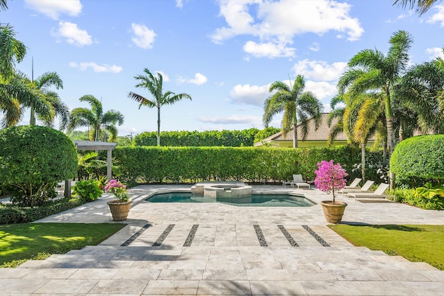 view of pool with a patio and a pool with connected hot tub