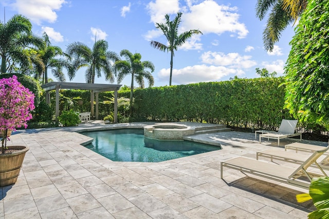 view of swimming pool with a pool with connected hot tub and a patio area