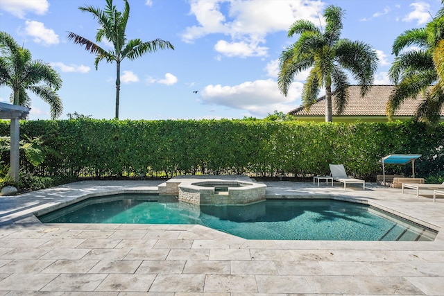 view of swimming pool featuring a patio area and a pool with connected hot tub