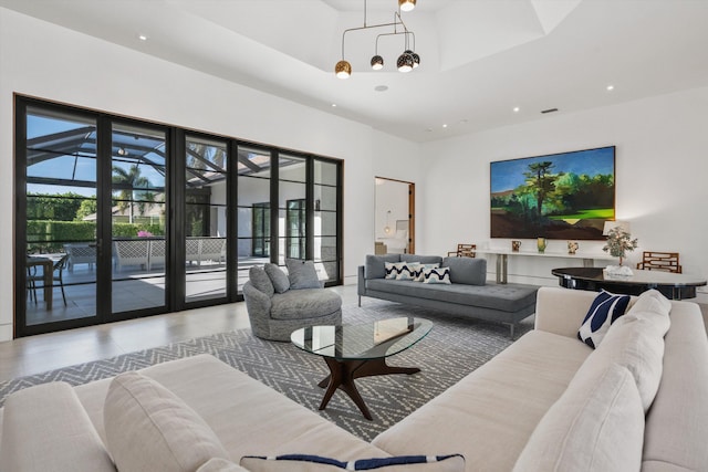 living area featuring tile patterned floors, a notable chandelier, and recessed lighting