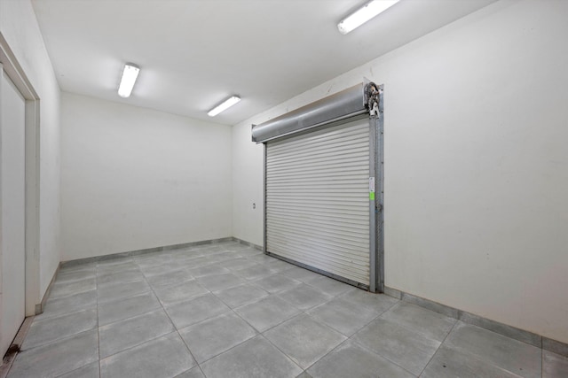 interior space with light tile patterned flooring and baseboards