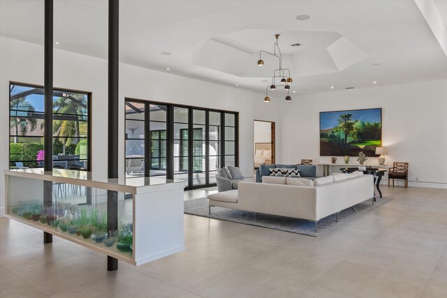 living area with a tray ceiling and a towering ceiling