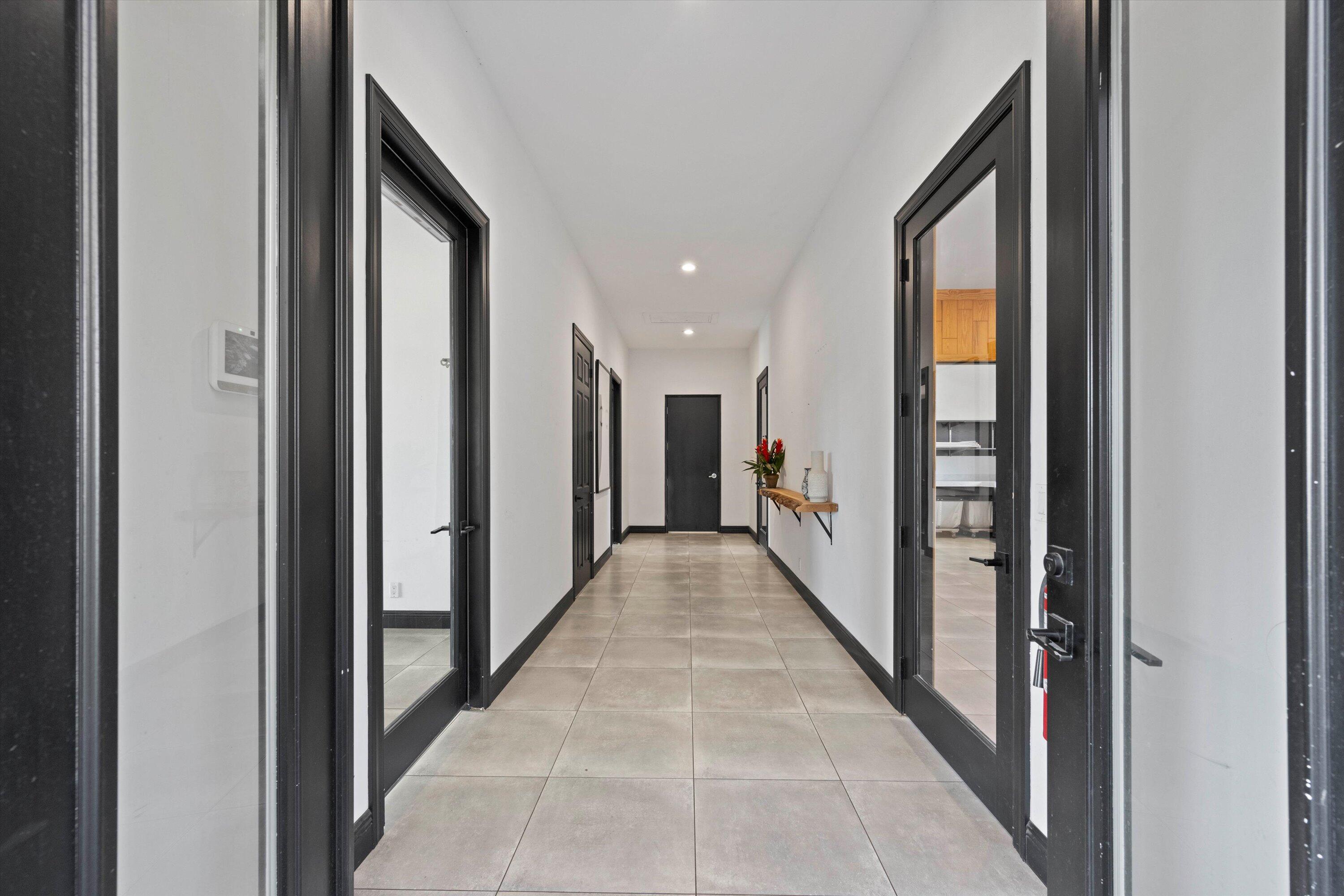 hall featuring light tile patterned floors, recessed lighting, and baseboards