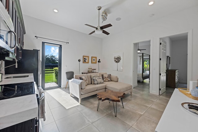 living room with a ceiling fan, light tile patterned flooring, recessed lighting, and baseboards