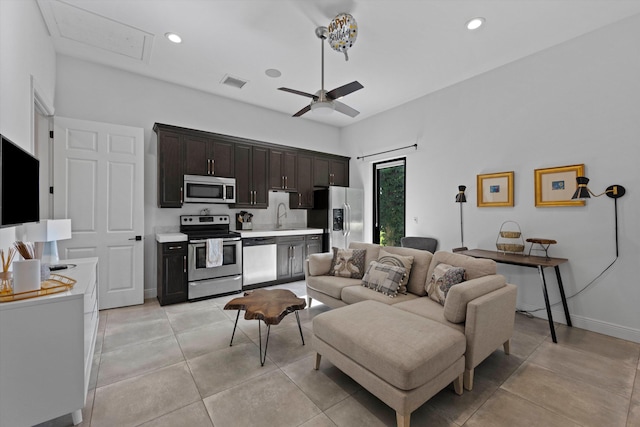 living area featuring light tile patterned floors, a ceiling fan, visible vents, baseboards, and recessed lighting