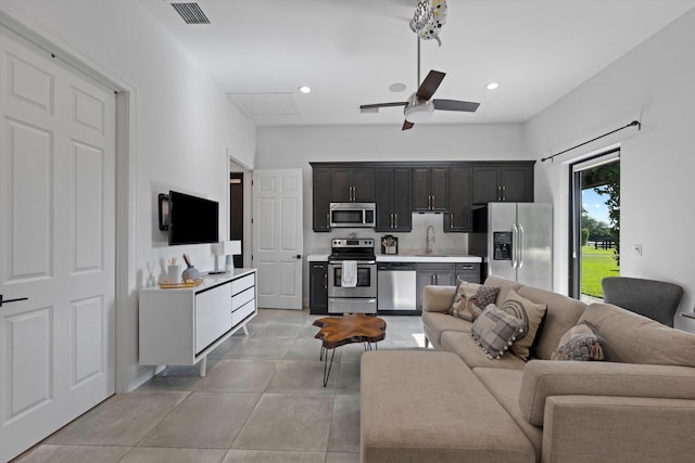 living area with light tile patterned floors, visible vents, recessed lighting, and a ceiling fan