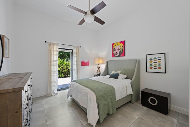 bedroom featuring ceiling fan, baseboards, light tile patterned flooring, and access to outside