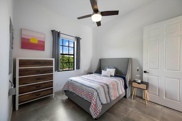 bedroom with tile patterned floors, a ceiling fan, and baseboards