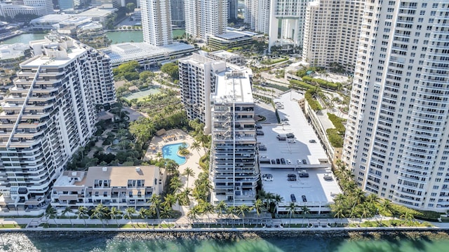 drone / aerial view featuring a city view and a water view