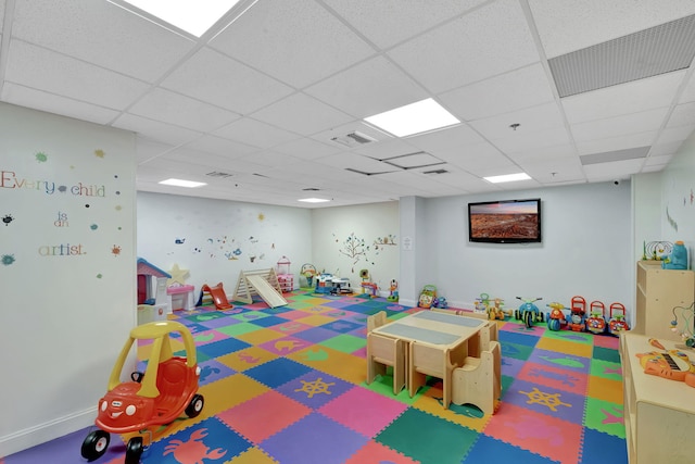 recreation room with visible vents and a paneled ceiling