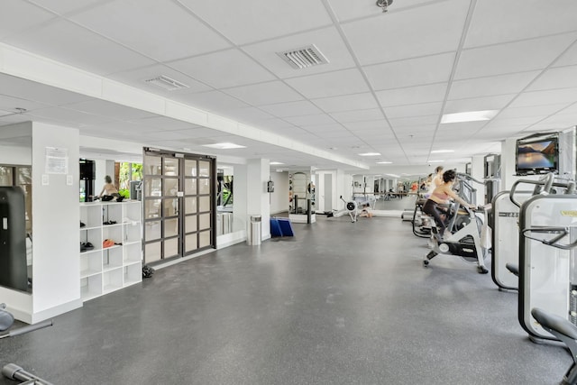 workout area featuring a paneled ceiling and visible vents